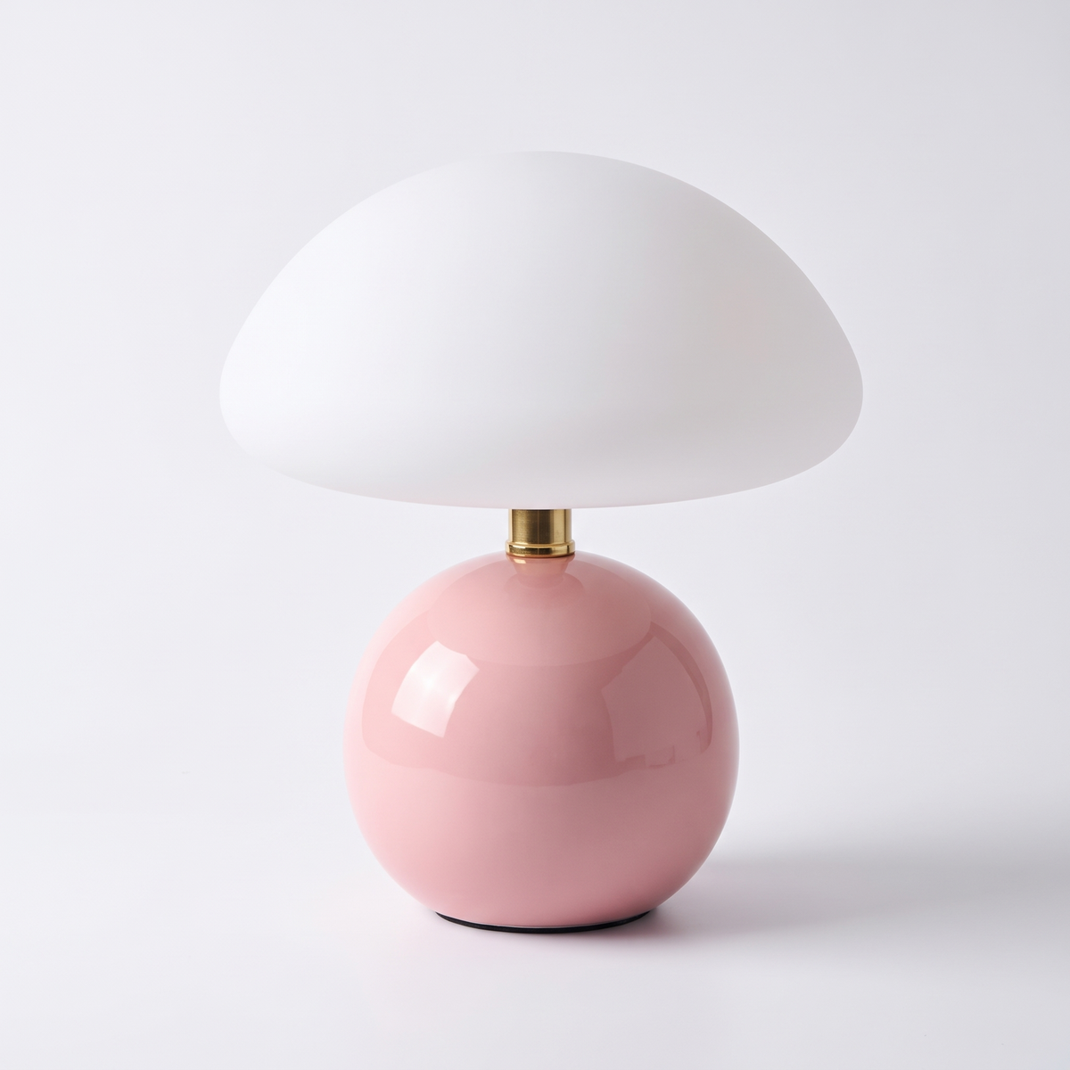 Blush ceramic mushroom lamp with glass dome on a white background