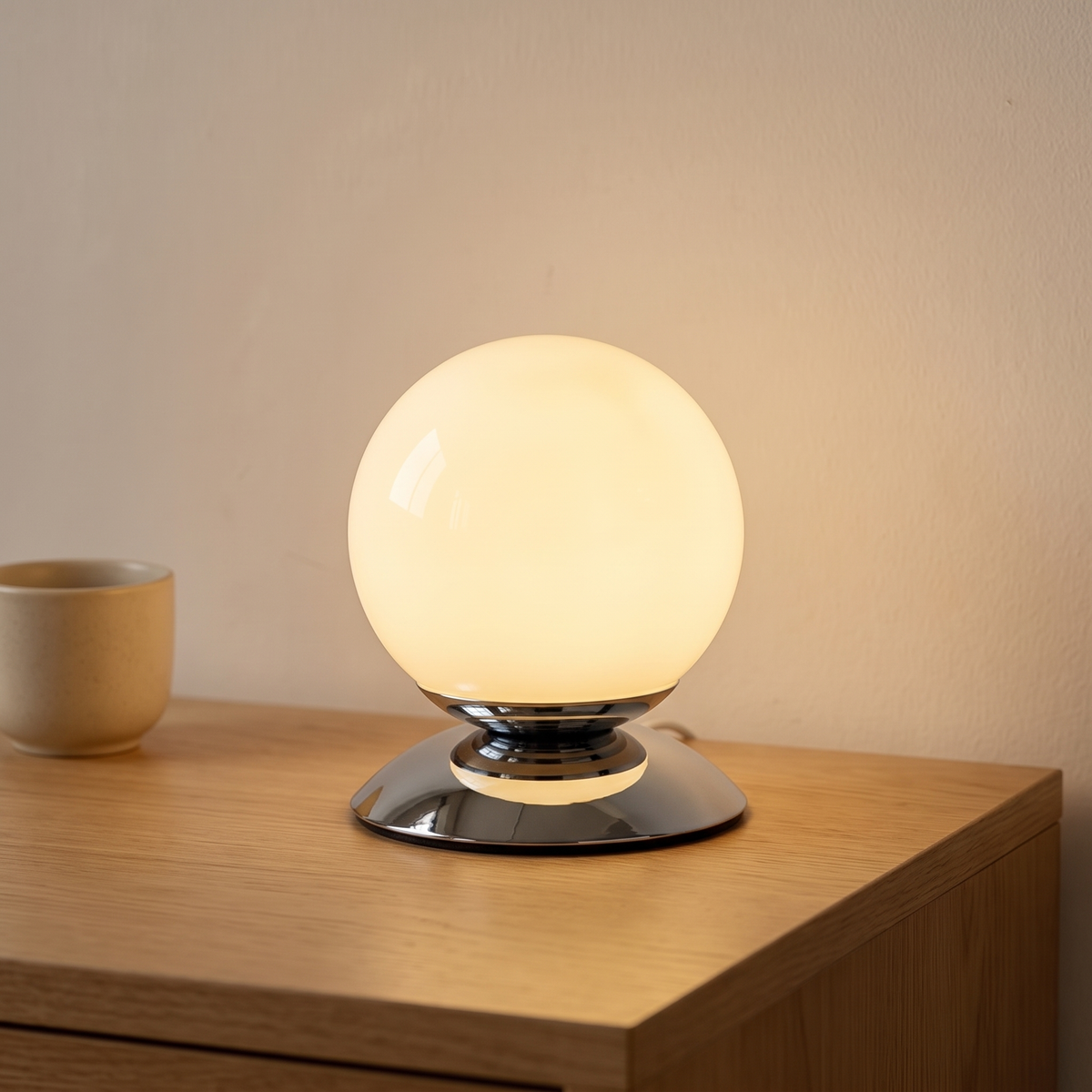 Cornsilk glass globe table lamp displayed in a warm modern interior