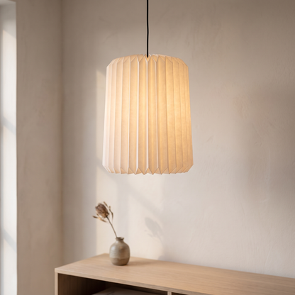 Folded paper pendant lampshade displayed in a warm modern interior