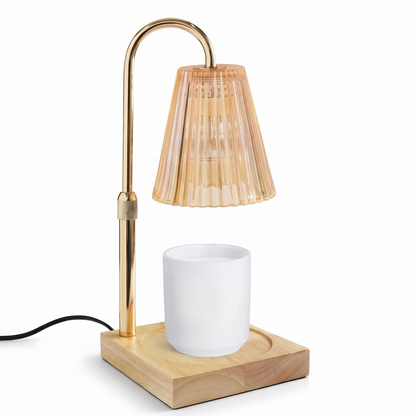 Gold candle warmer lamp with wooden tray on a white background