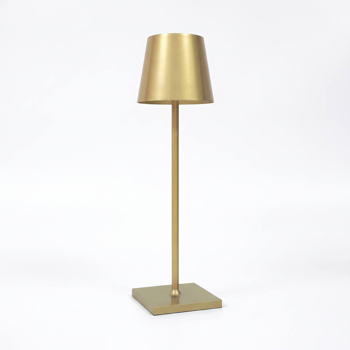 Gold cordless table lamp on a white background
