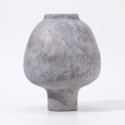 Handmade grey stoneware pedestal vase on a white background