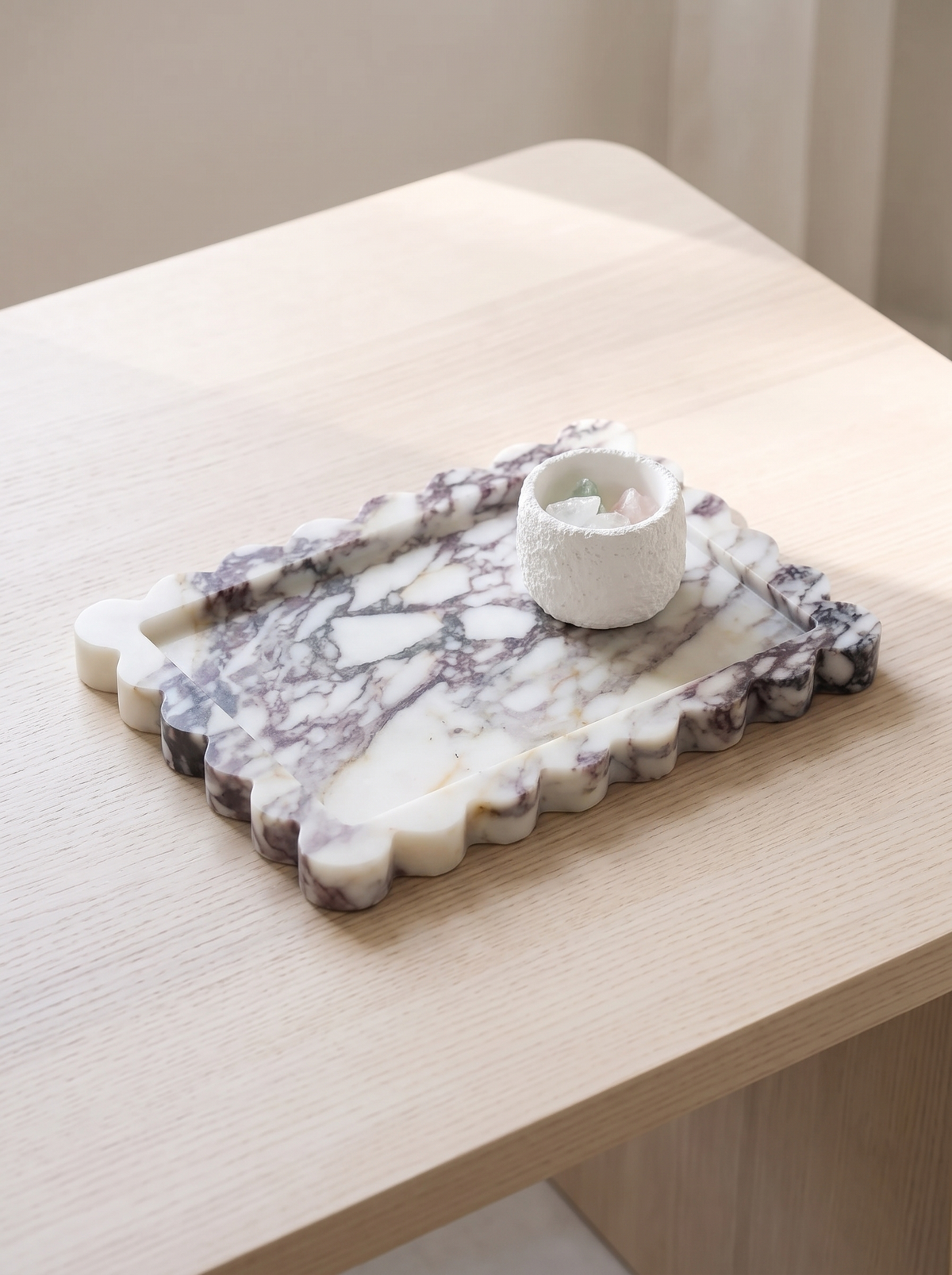 Scalloped stone tray on a pale wooden table