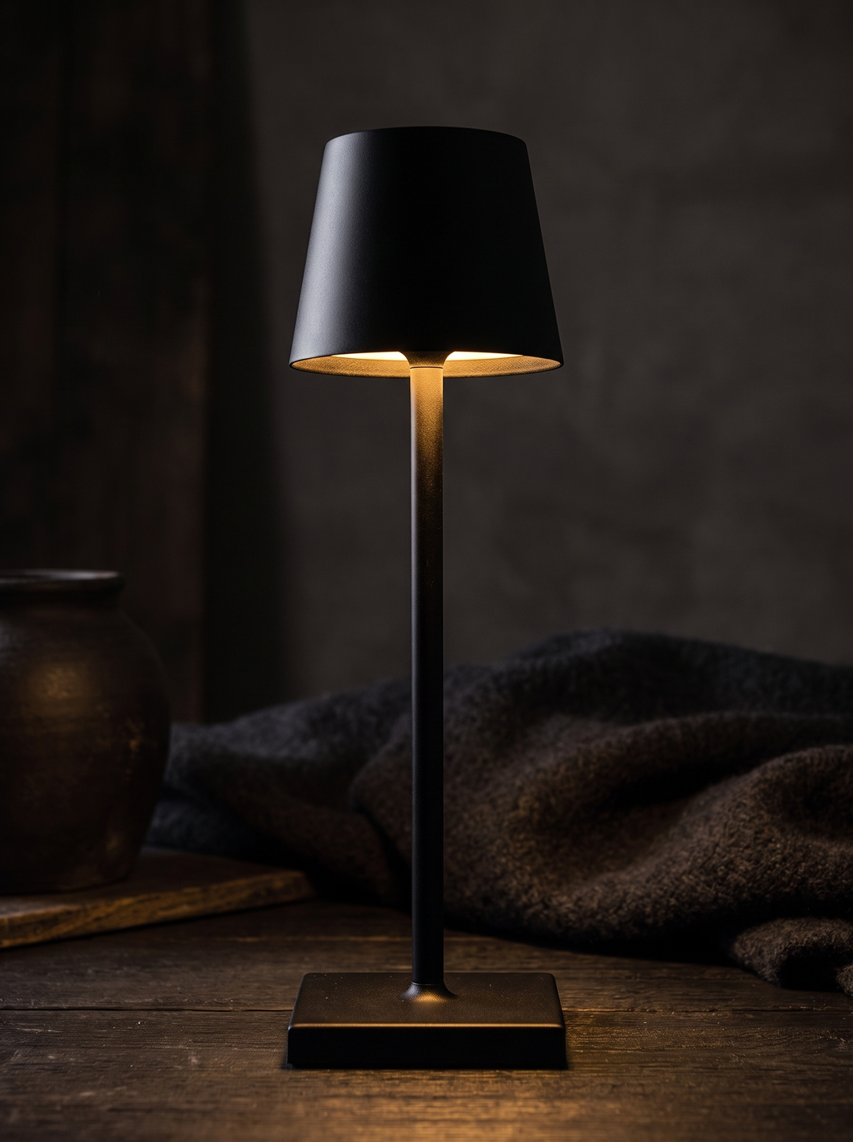 Close view of a matte black cordless lamp
