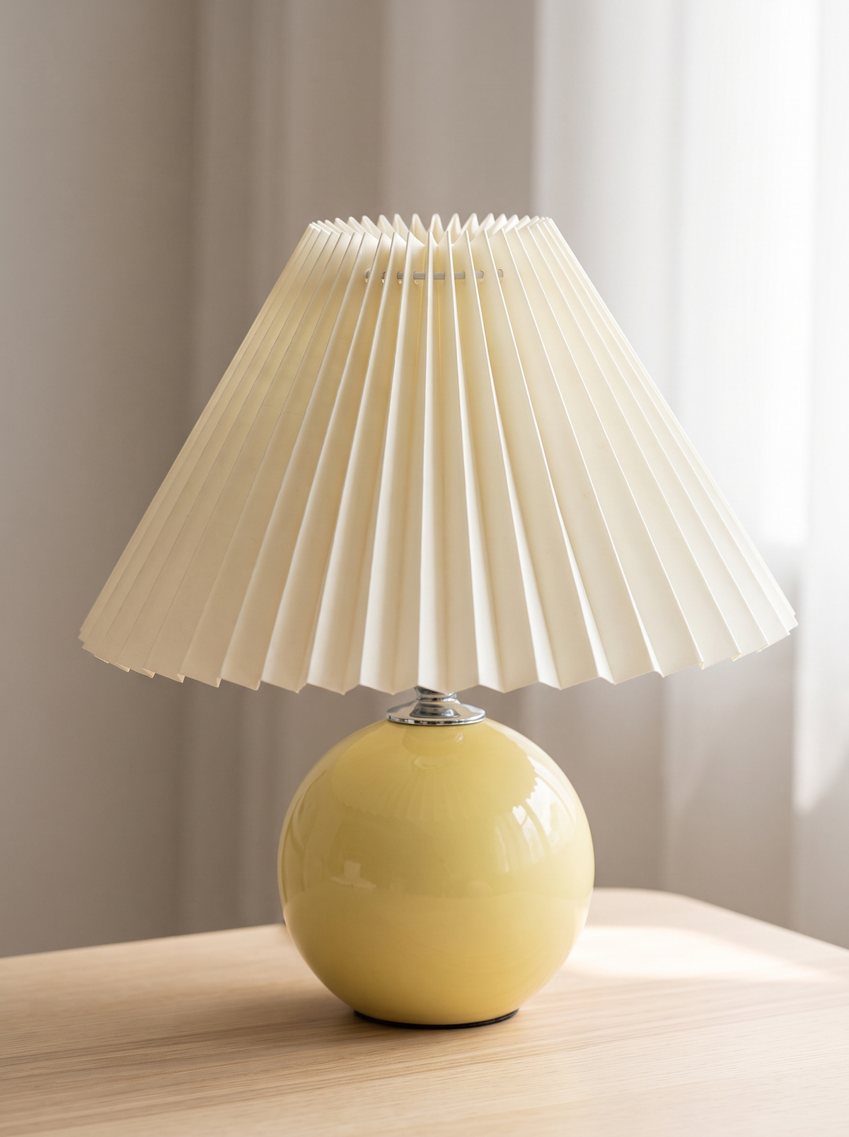 Close view of a pleated shade on a ceramic lamp