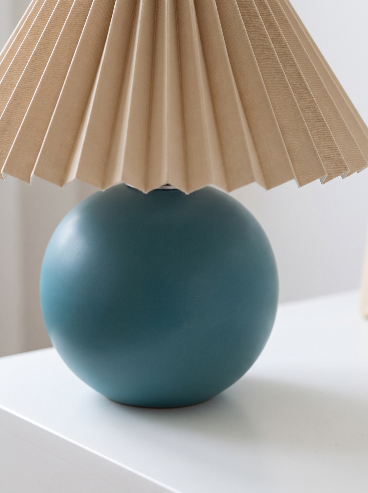 Close view of a matte ceramic lamp base
