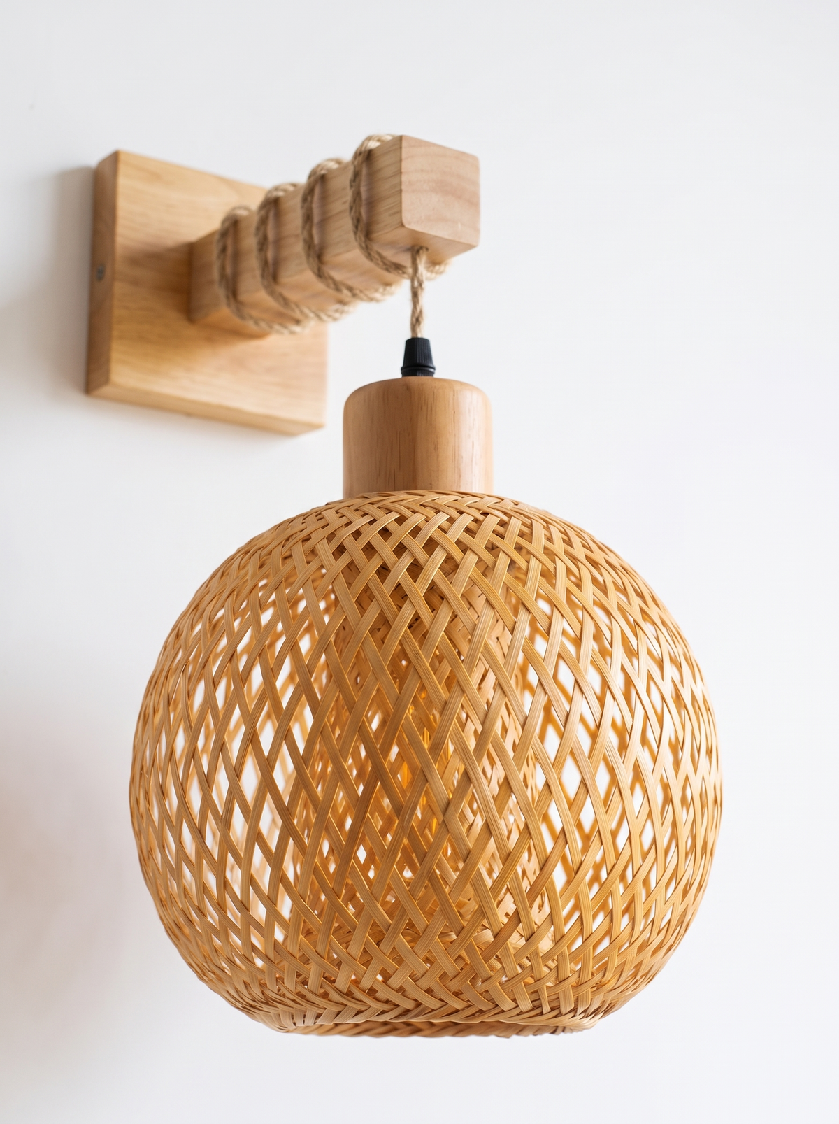 Close view of a handwoven rattan sconce shade