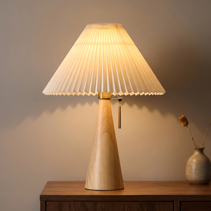 Oak table lamp with pleated shade displayed in a warm modern interior