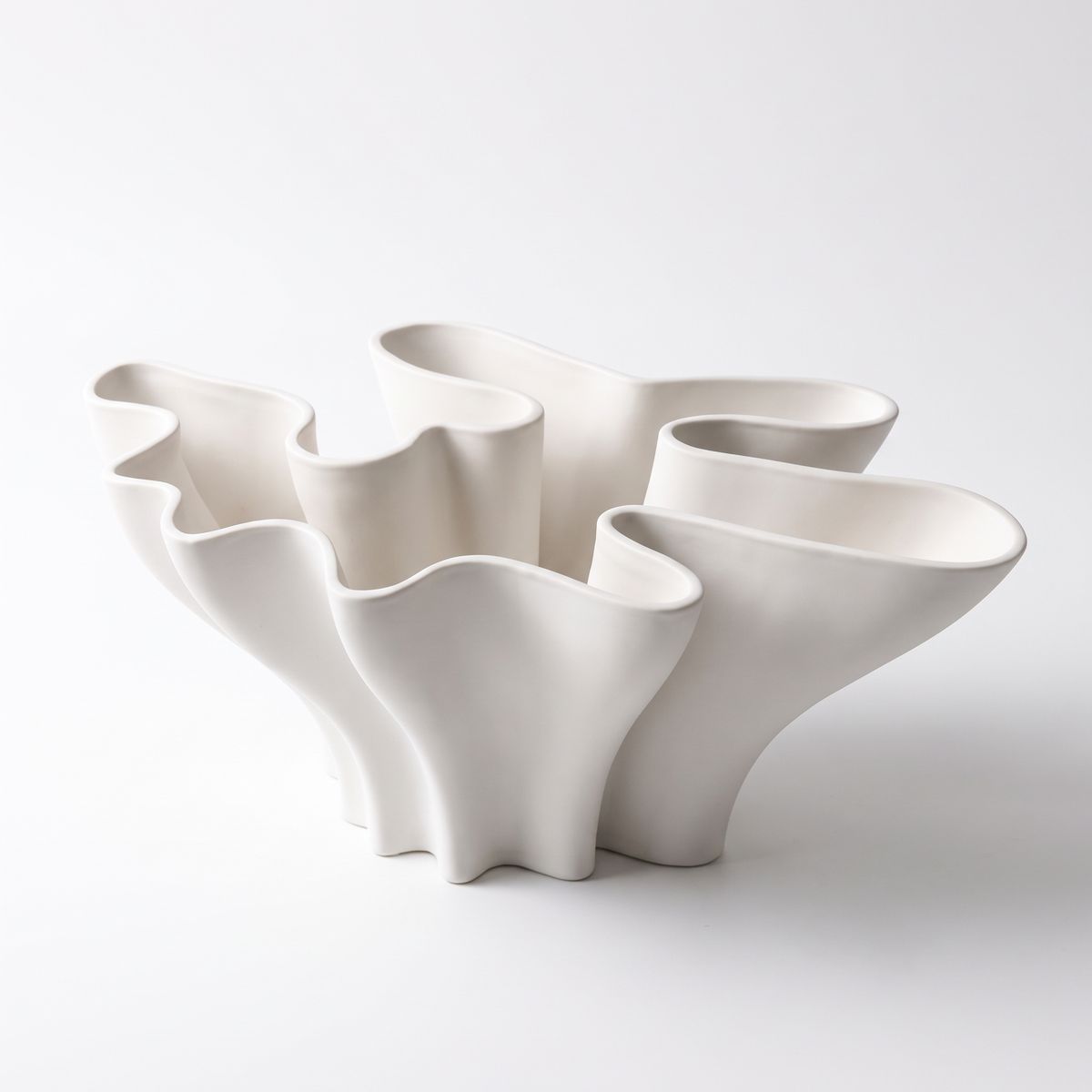 White ceramic coral sculpture vase on a white background